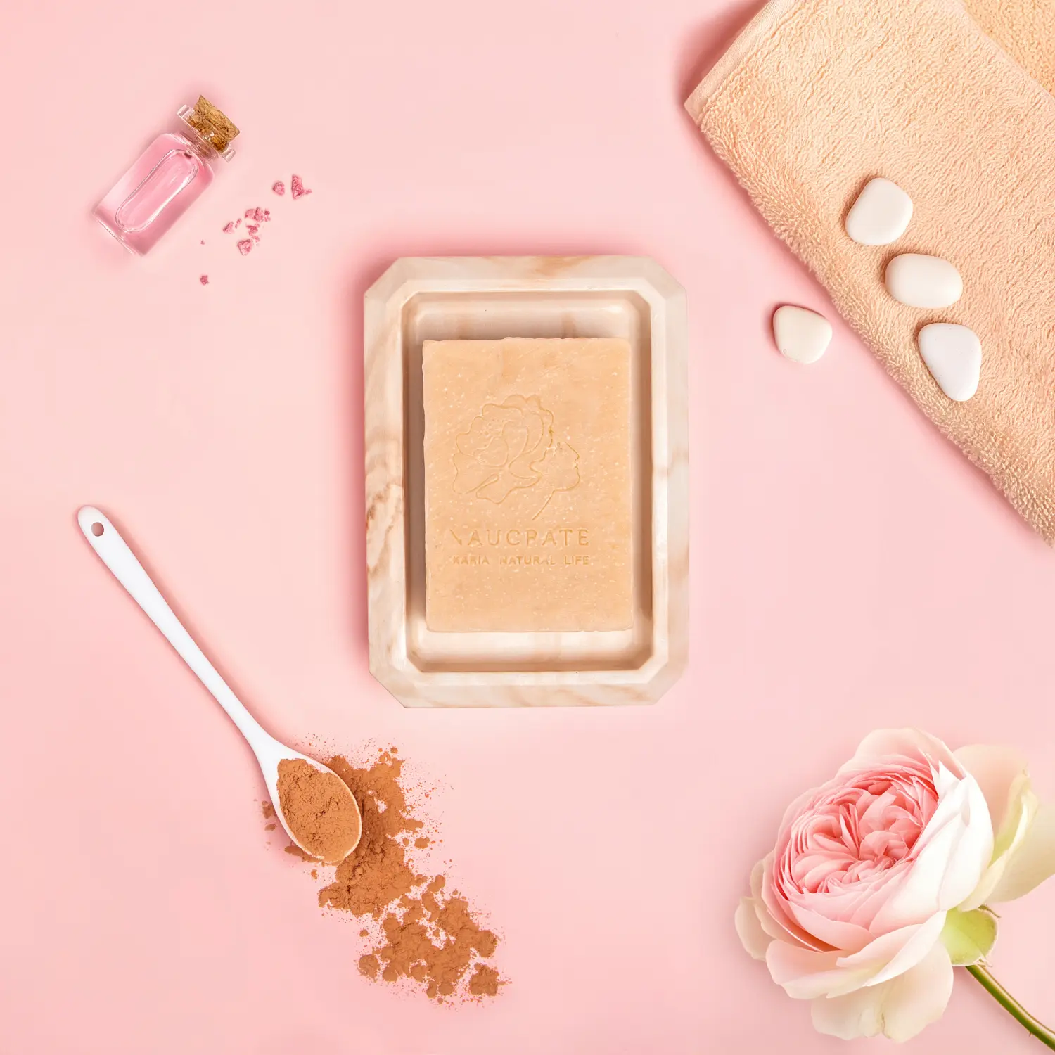 Professional hero shot of a sweet rose soap bar with cinnamon and oils, against a solid pink background